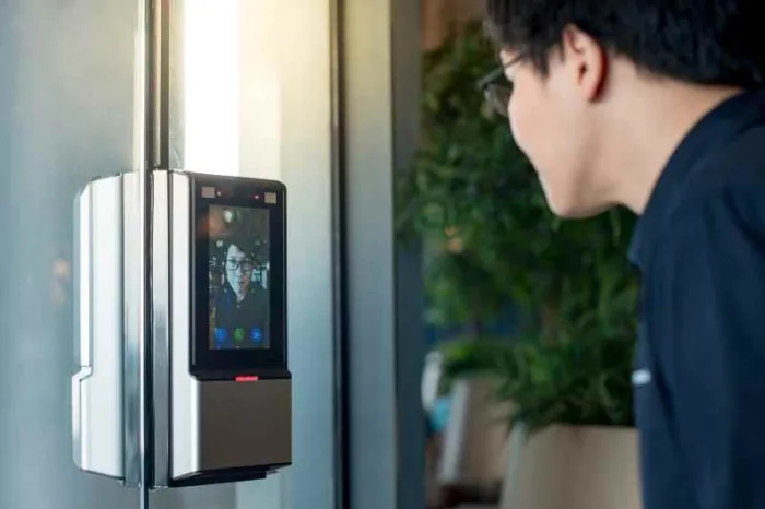 someone using facial recognition biometric access control