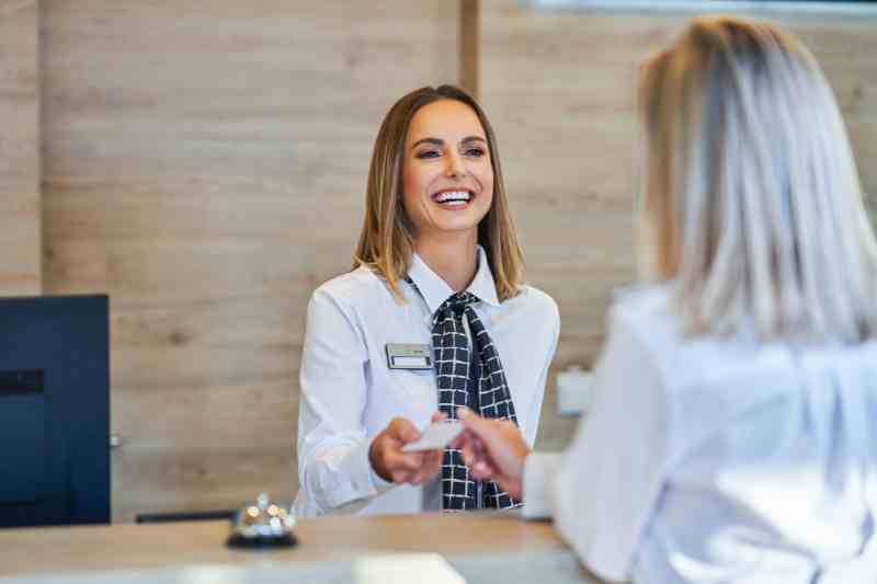 Hotel receptionist using front desk software to print out a hotel key.
