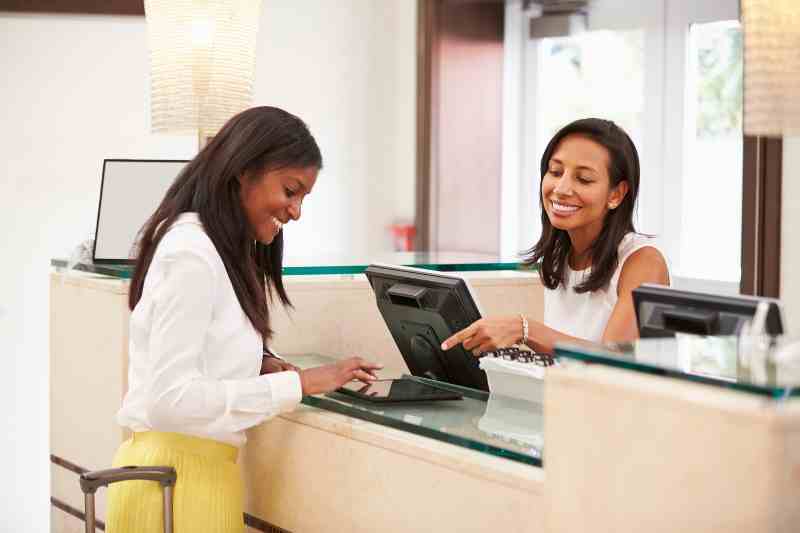 Woman using front desk software to check herself in.