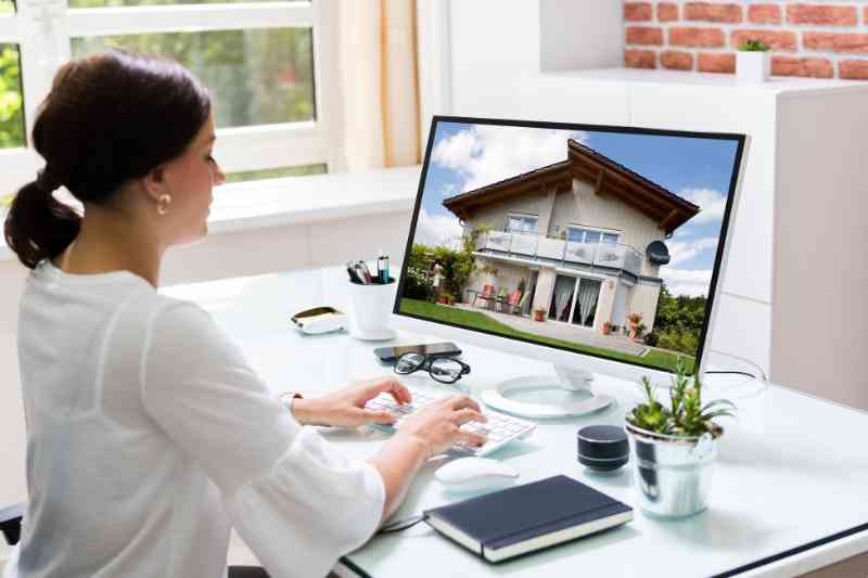 Woman using a property management software company to oversee her property.