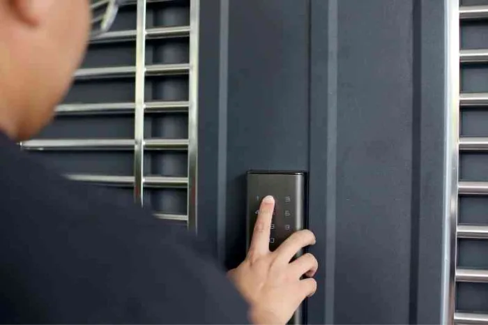 Person using a lock with the best smart lock battery life at a door.